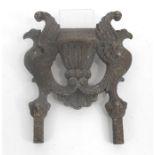 A 19thC cast iron boot scraper, a central urn flanked by a pair of eagles 28cm x 35cm