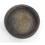 An Islamic shallow bowl, decorated with central roundel containing script and further figural