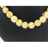 An early 20th century turned and pierced ivory bead necklace.