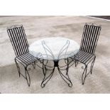 A glass and metal conservatory table 86cm diameter and a pair of matching chairs