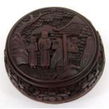 A Chinese cinnabar lacquer box and cover, decorated with figures, 10cm diameter.