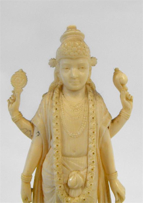 An early 20th century Indian ivory carving depicting a multi armed deity standing on a lotus flower, - Image 2 of 2