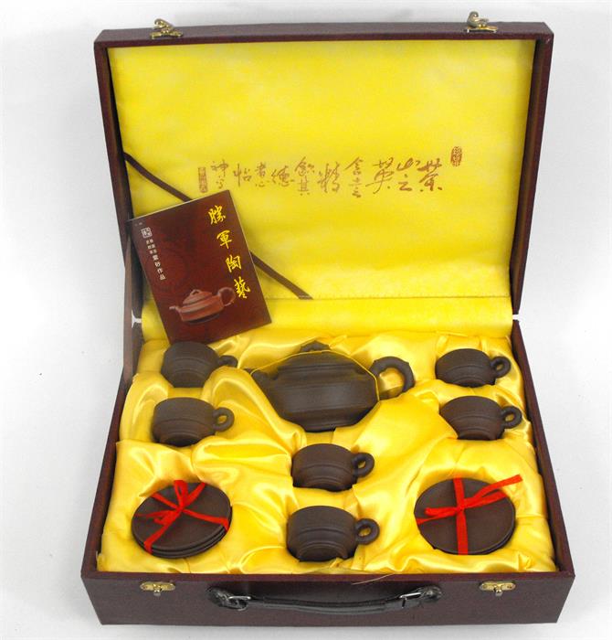 A Chinese Yixing pottery tea set in fitted case.