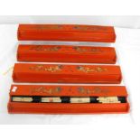 A set of four Chinese lacquer Mahjong tile boxes decorated with gilded dragons on a red ground (4).