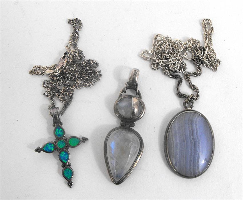 A silver and agate pendent and chain, another similar and a silver crucifix (3)