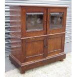 A mahogany side cabinet, having a pair of glazed doors with cupboard beneath 62cm wide