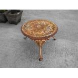 A cast iron garden low table 59cm diameter