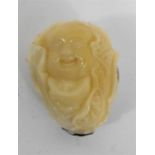 A Chinese vegetable ivory carving depicting a Buddha among foliage 5.5cm high