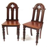 A pair of Victorian mahogany hall chairs.