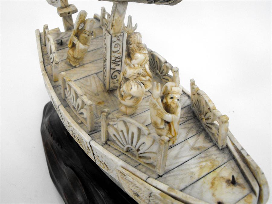 An early 20thC Japanese bone boat with five figures on a carved wooden base (some losses) 24cm x - Image 4 of 4