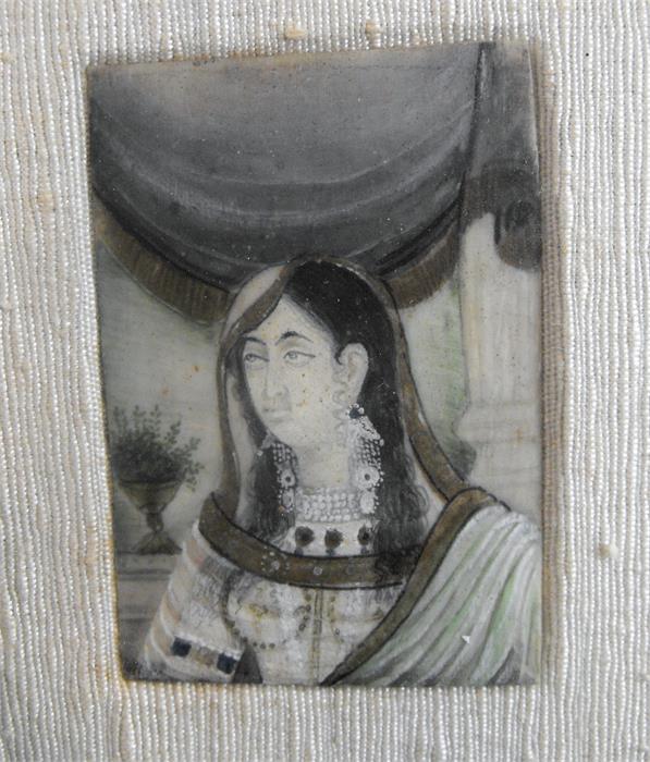 An Indian portrait miniature depicting a young woman, 5cm x 7cm