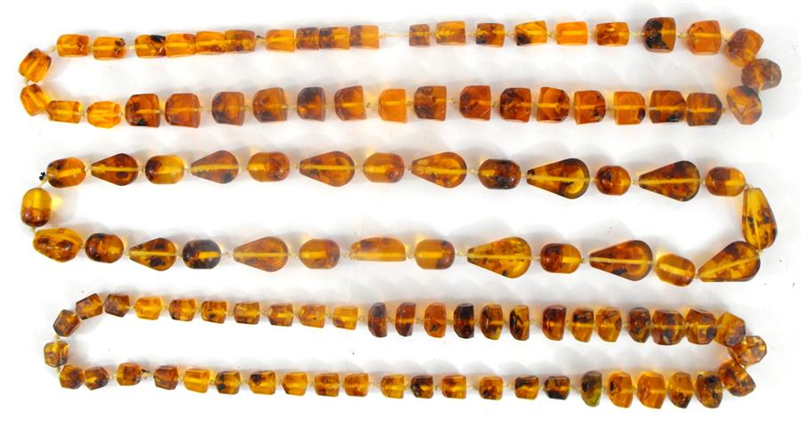 Three strings of amber coloured beads