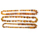 Three strings of amber coloured beads