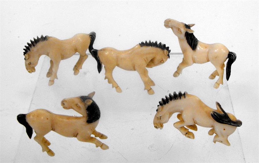 A group of five early 20th century Chinese ivory carvings in the form of horses in various poses (