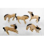 A group of five early 20th century Chinese ivory carvings in the form of horses in various poses (