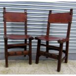 A pair of Arts and Crafts leather and oak chairs