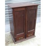 A Mahogany cupboard, the pair of cupboard doors above two short drawers 47cm wide
