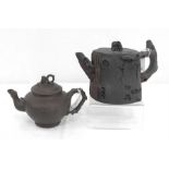 A Chinese Yixing pottery teapot, decorated in relief with flowers, 10cm high, together with