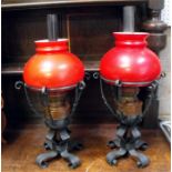 A pair of Continental Arts & Crafts style copper and wrought iron table oil lamps, 53cm high.