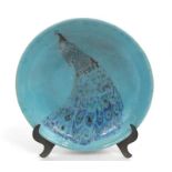 A Studio Pottery bowl decorated with a peacock on a turquoise ground (AF) 23cm diameter