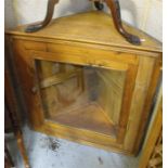 A pine glazed corner cupboard, 77cm wide.