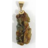 A Chinese jade pendant carved with entwined panthers mounted with a yellow metal loop set with a