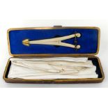 A Victorian leather glove box, containing kid goves and bone glove stretchers (lacks handle) 27cm