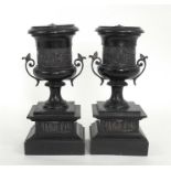 A pair of Victorian black slate garnitures decorated classical scenes 29cm high