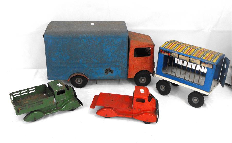 A green painted Tri-ang toys truck, another similar, a Tri-ang circus truck, and a tin plate