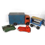 A green painted Tri-ang toys truck, another similar, a Tri-ang circus truck, and a tin plate