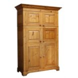 A Chalon pine kitchen unit, a pair of panelled cupboard doors above a fitted Miele freezer and a