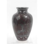 A Richard Ginori vase, decorated with deer and flowers silver overlay on a deep red ground, marked