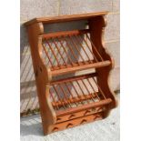 A pine wall mounted plate rack, inset with a 1938 penny, 51cms wide.