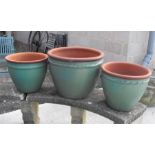A set of three terracotta planters, the largest 48cms diameter.