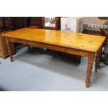 A large pine kitchen table with two drawers, on turned legs, 228 by 89cm.