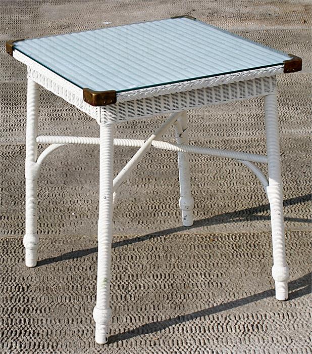 A Lloyd Loom style glass square topped garden table, 61cms wide.