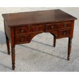 A 19th century mahogany writing table with two long drawers above two short drawers, on turned legs,