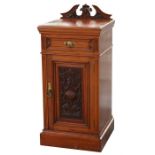 A late 19th century pot cupboard with central drawer above a carved panelled door, on plinth base,