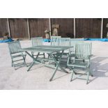 A wooden painted garden table and six matching folding chairs (7).