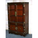 A Korean hardwood display cabinet, two glazed doors with cupboards beneath, 70cms wide; and a Korean