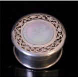 An Asprey silver circular box, dated London 1913, with pierced top inset with mother of pearl