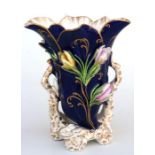 A 19th century Rockingham style vase, decorated with flowers on a deep blue ground, 18cm high
