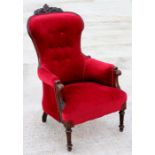 A Victorian mahogany button back upholstered armchair.
