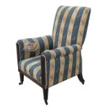 A William IV oak upholstered armchair on turned tapering front supports.