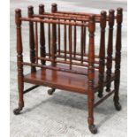 An Edwardian walnut Canterbury with ring turned supports, 40cm wide.
