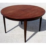 A mid 20th century Danish rosewood extending dining table, makers label Omann Jun to underside, with