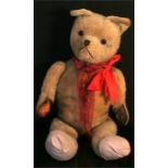 A large vintage jointed teddy bear (a/f), 84cms high.