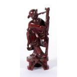 A Chinese rootwood carving depicting a musician, 15.5cm high.