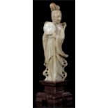 A Chinese carved green soapstone figure in the form of Guanyin, 19cm high, and another similar in