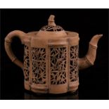 A late Qing / early Republic Period Chinese Yixing reticulated teapot decorated with bamboo,